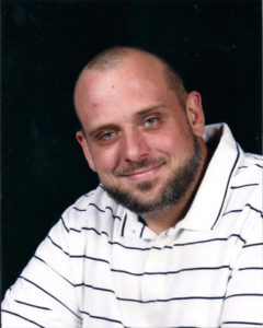 Joshua Baud, owner of One Sharp Store, standing in the parts warehouse